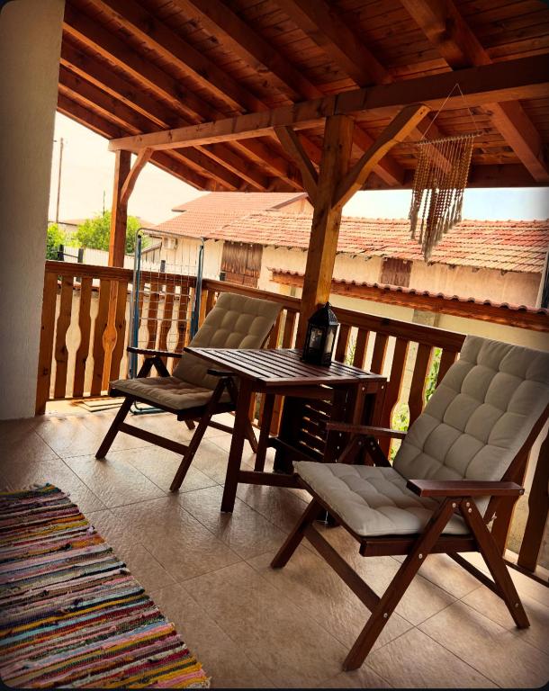 a patio with two chairs and a table on a deck at Guest House Vergie, Fully Private in Sapareva Banya