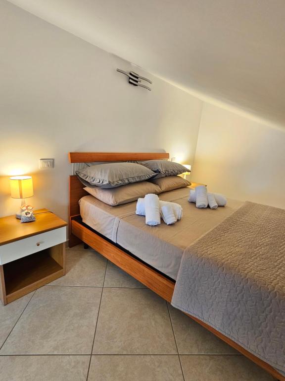 a bedroom with a large bed with two pillows at Attico Bellavista in Termoli