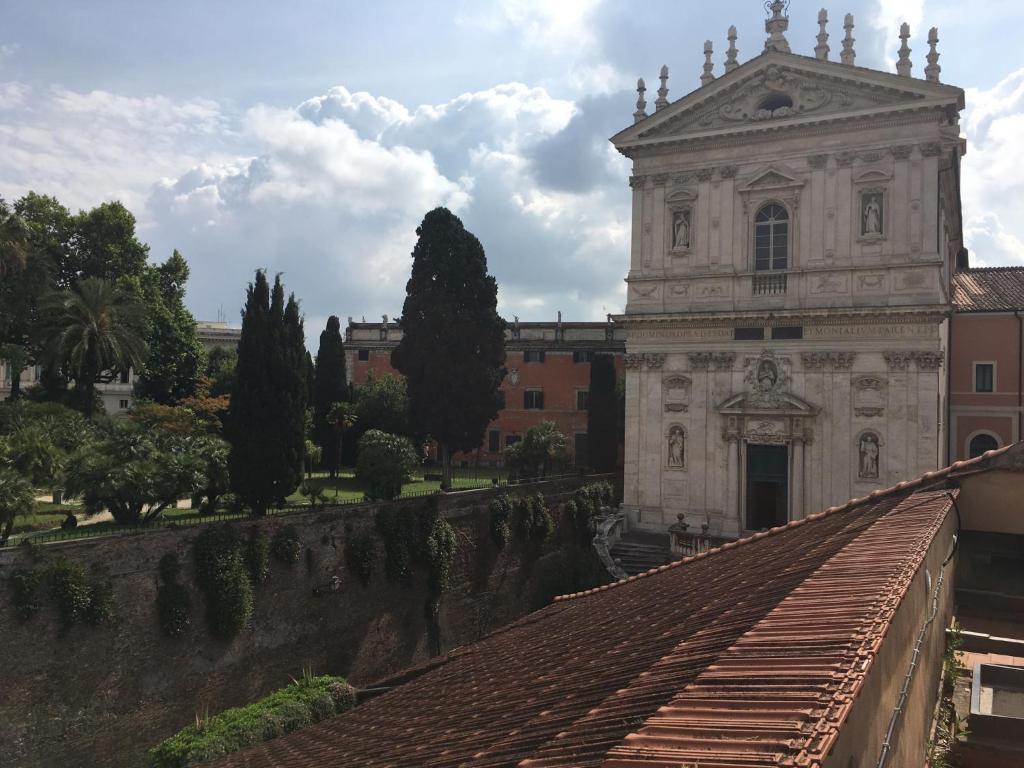 an old building with a tower and a roof at Roma Luxus Hotel in Rome