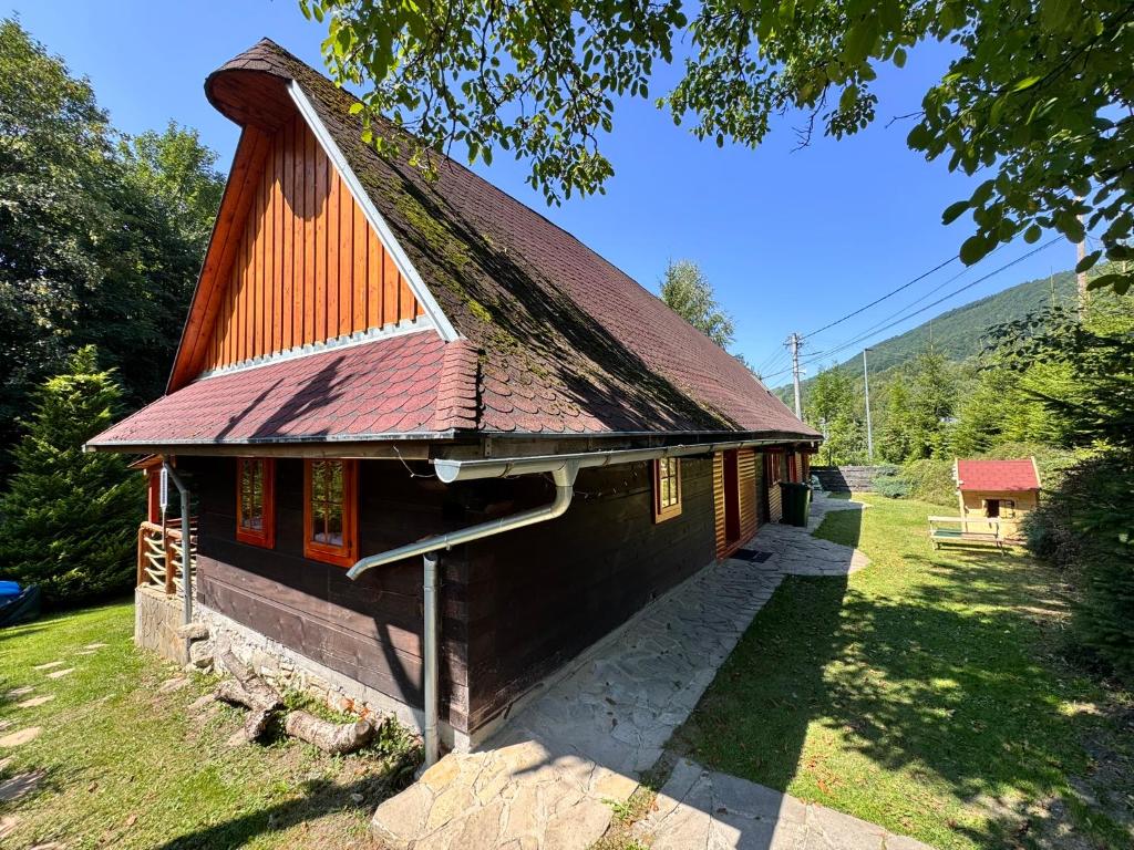 a small house with a red roof at Chatka pod orechom in Terchová