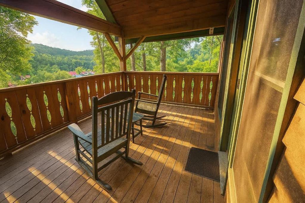 two chairs sitting on a porch of a cabin at New Alpenrosen Haus-Arcade Hot Tub Sauna Views in Helen