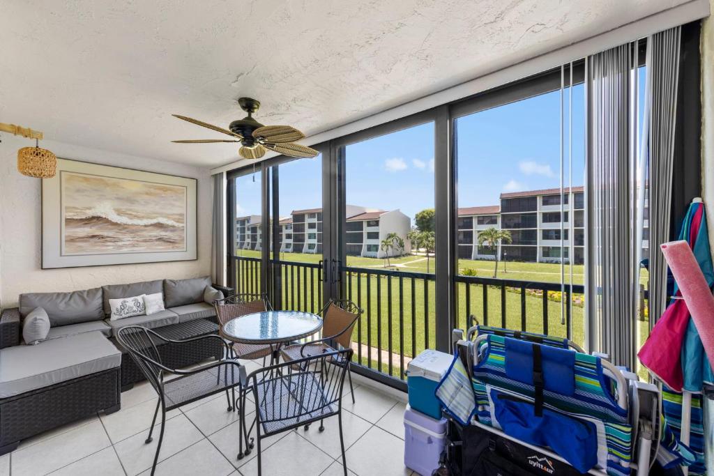 a living room with a couch and a table at Beachfront Loggerhead Cay Pool Pickleball & Bikes in Sanibel