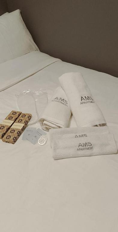 a bed with two towels and a remote control on it at AMS Hostel Butuan City in Butuan