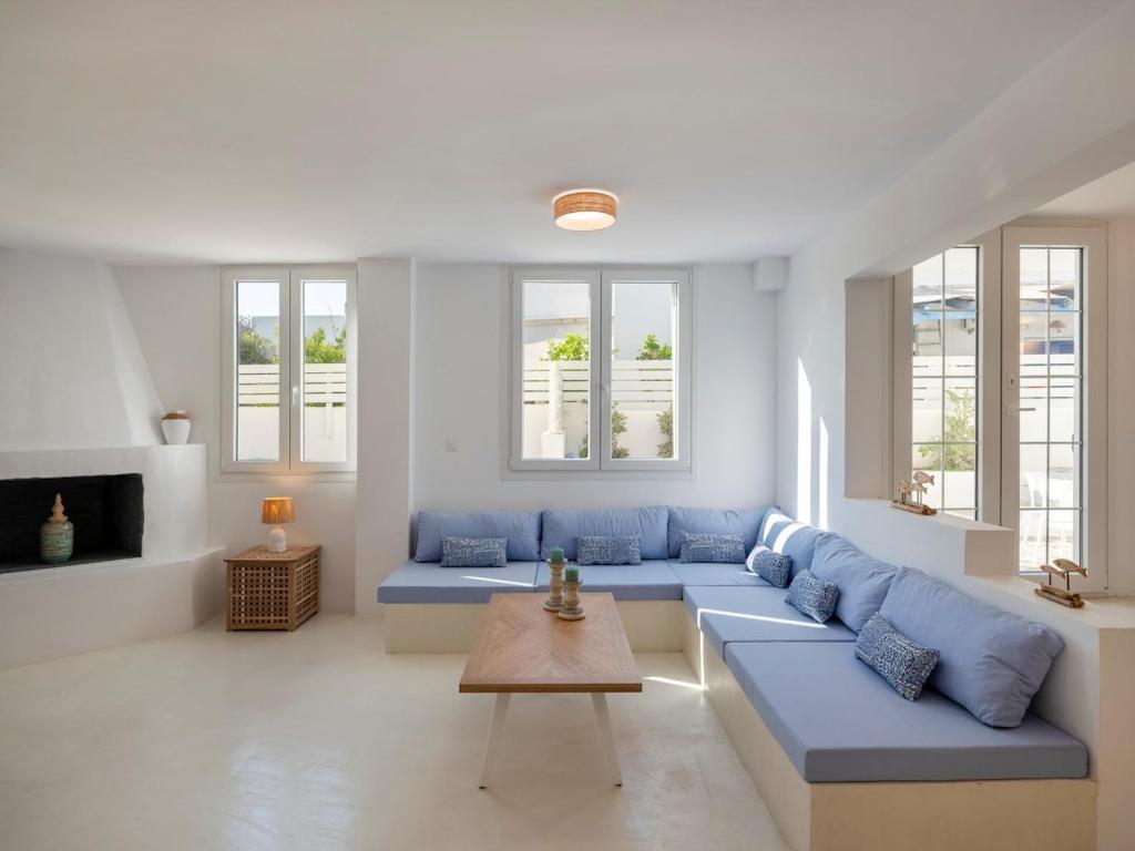 a living room with blue couches and a table at Casa De Tamara Paros in Kampos Paros