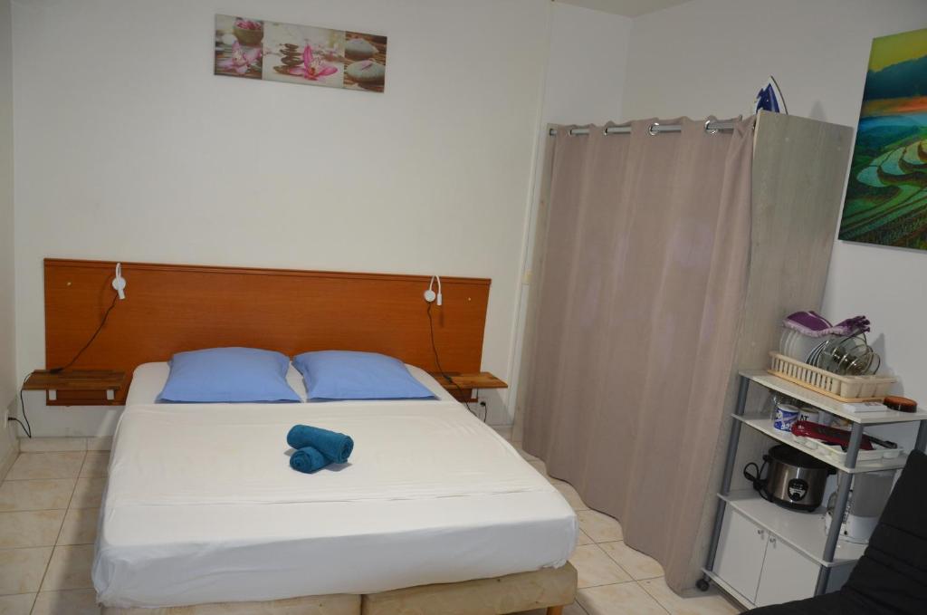a bedroom with a bed with a blue stuffed animal on it at Kaz Gwayav Dous in Gros-Morne