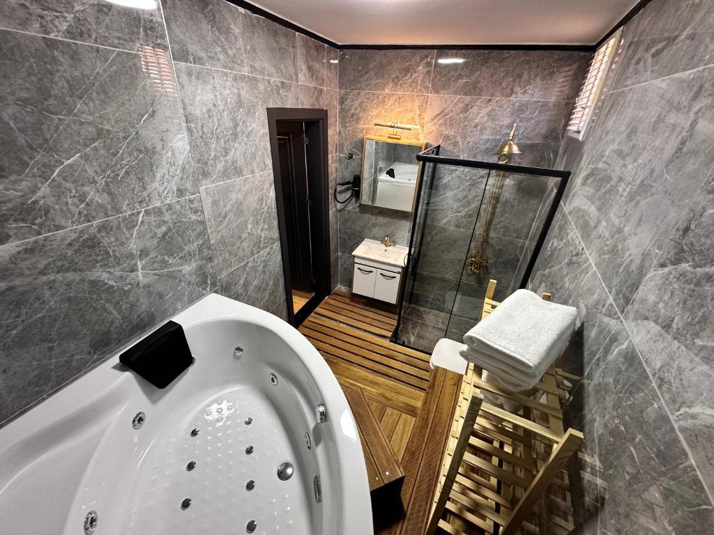 a bathroom with a bath tub and a sink at MorAgop Suites in Istanbul
