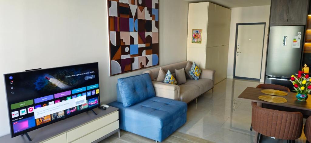 a living room with a couch and a flat screen tv at SEA BREEZE Baku-FH in Baku
