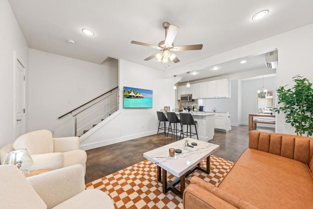a living room with a couch and a table at The Festival Retreat KING Bd Cajun Luxury Book Now in Lafayette
