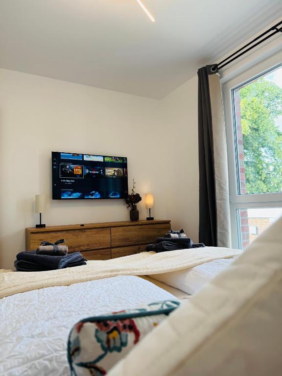 Ένα ή περισσότερα κρεβάτια σε δωμάτιο στο Familientraum 10min zur Ostsee und nach Lübeck Zentrum mit Parkplatz & Balkon