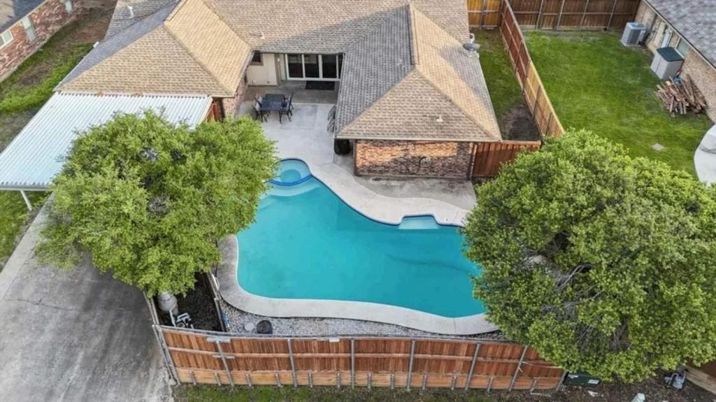 an overhead view of a swimming pool in a house at Family Haven Pool, Game Room, Near Cowboys Hq in Plano