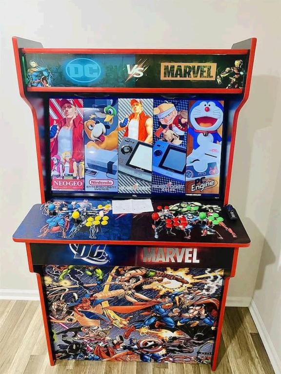 a table with marvel comics on top of it at 2 mins walk to Benz stadiumArcade game Sleeps 11 in Atlanta