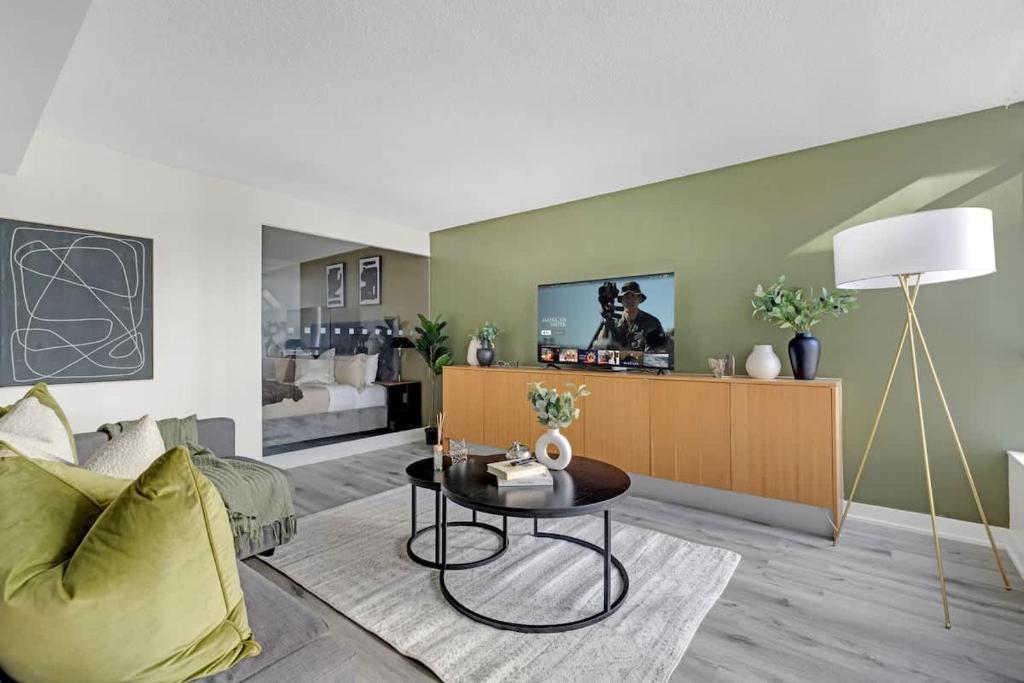a living room with a couch and a table at Luxury Waterfront Escape Stylish 3BR Condo in Toronto