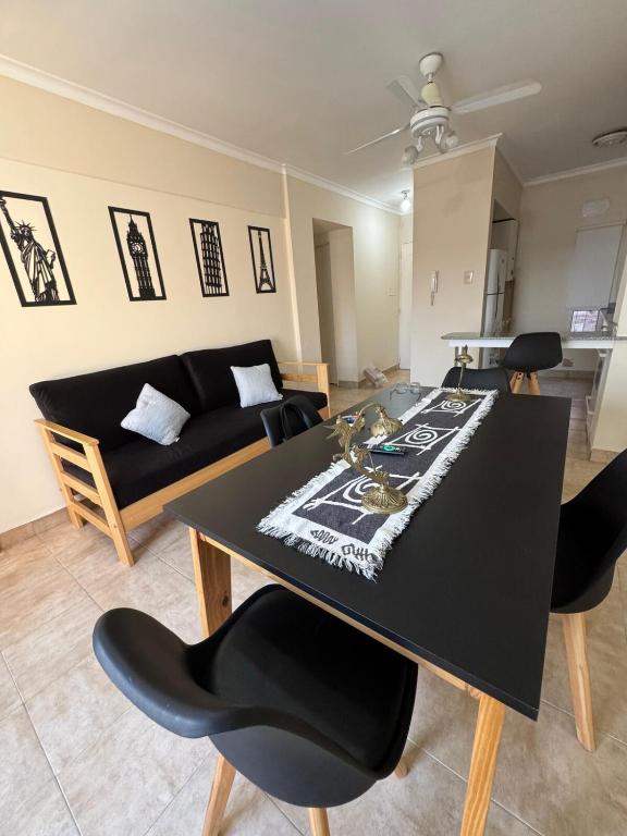 a living room with a black table and chairs at Departamento centrico Avenida Cordoba Edificio Campanarios XIX in Esperanza