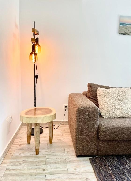a living room with a couch and a table at 1bd Apartment close to beach in Lourinhã