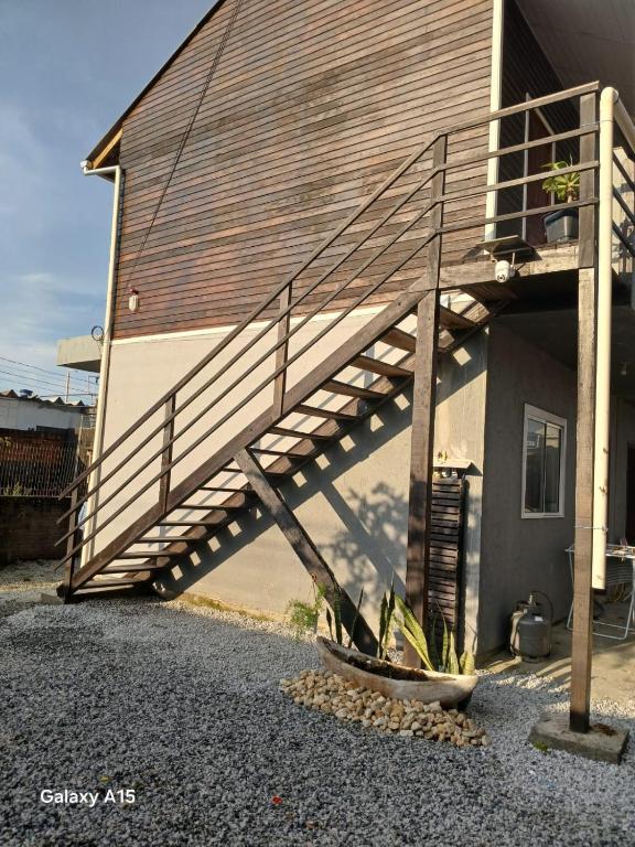 a wooden staircase on the side of a building at Vilamar in Florianópolis