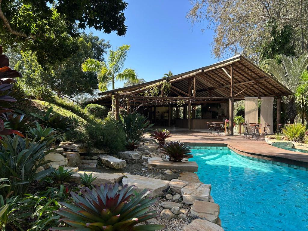 a swimming pool in a yard with a pavilion at Fazenda Boutique Vila dos Eucaliptos in Atibaia