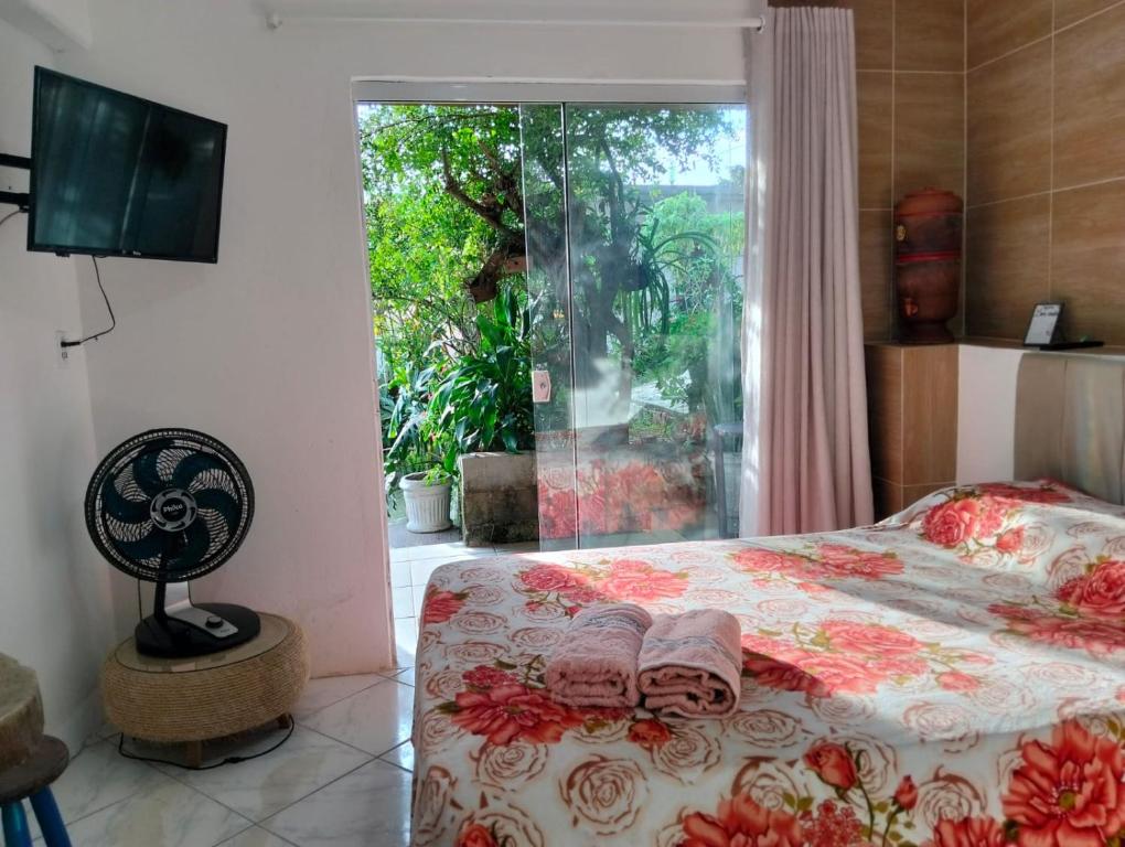a bedroom with a bed with two towels on it at Suíte com Entrada Independente in Florianópolis