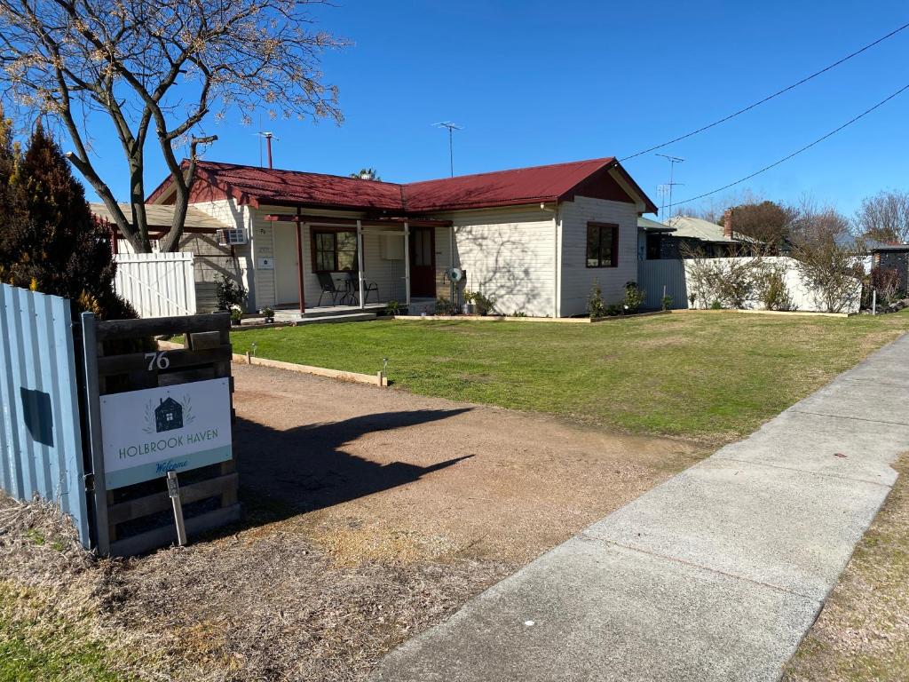 a house with a sign in front of it at Holbrook Haven - Bed and Breakfast in Holbrook