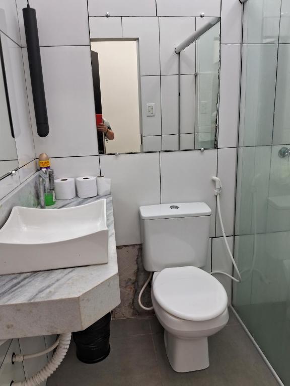 a bathroom with a toilet and a sink and a mirror at Casa blanca in Belém