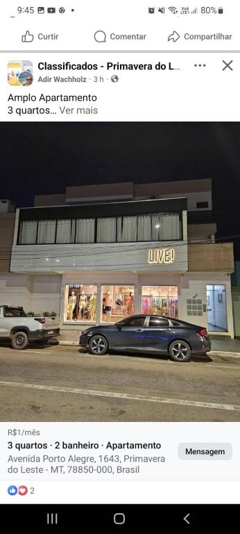 a picture of a car parked in front of a store at Apartamento no centro in Primavera do Leste