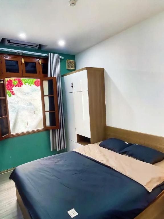 a small bedroom with a bed and a window at TV-Netflix STU 302 Near Uncle Ho's Mausoleum in Hanoi