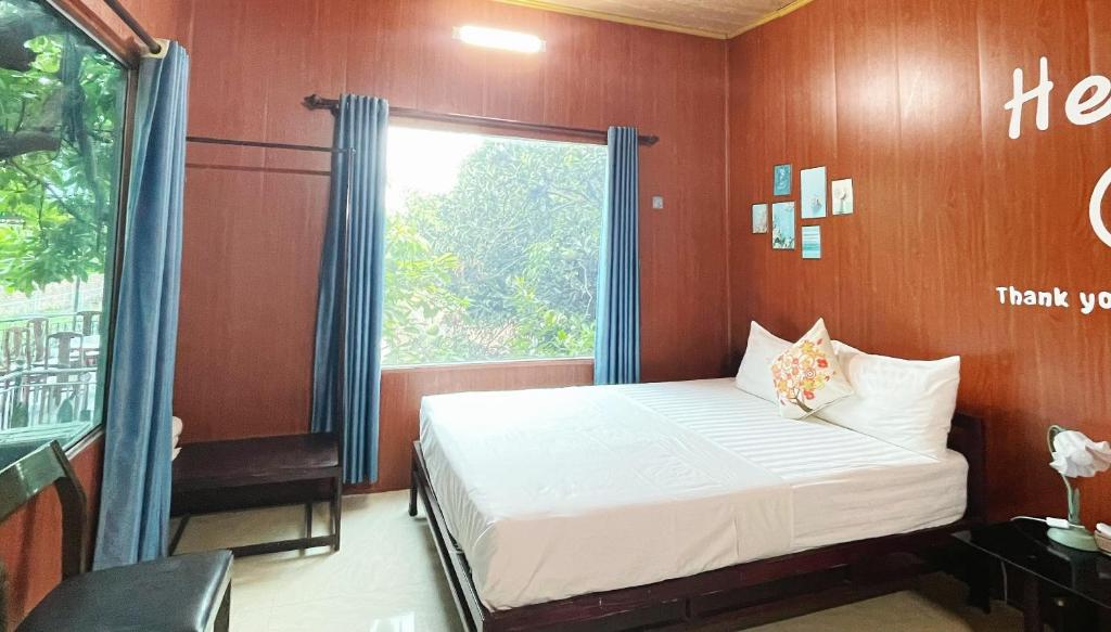a bedroom with a bed and a window at Vani's Home in Ninh Binh