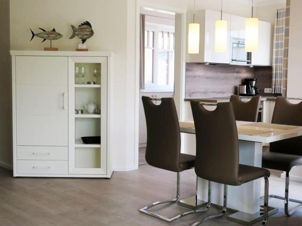 万根沃格Bootshaus Achterstag的带餐桌和椅子的厨房