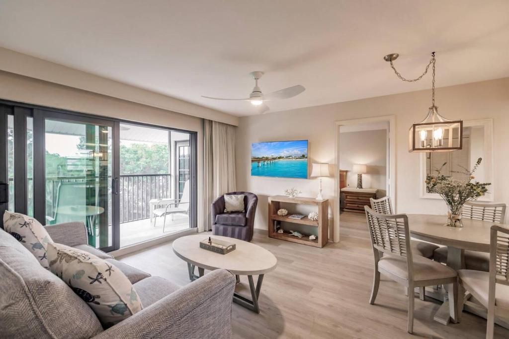 a living room with a couch and a table at Park Shore Resort Deluxe Condo Top FloorBLDG F 339 in Naples