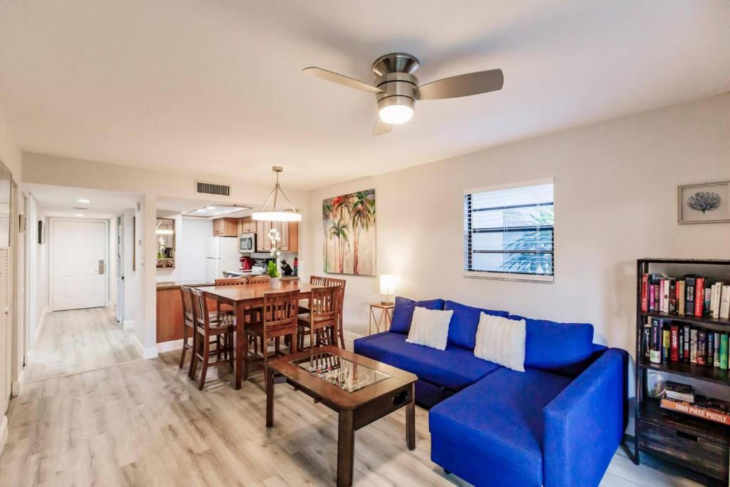 a living room with a blue couch and a table at Park Shore Resort-1st Floor Condo-Park 101 in Naples