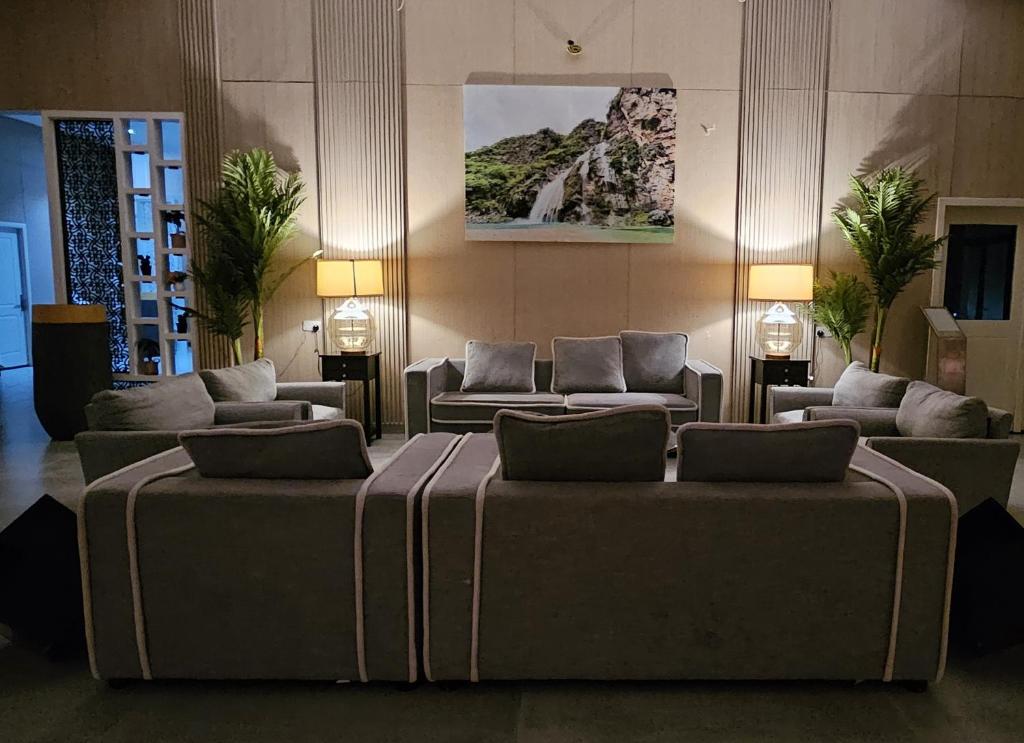 a living room with couches and couches at Sugardunes Beach Resort in Ghadw