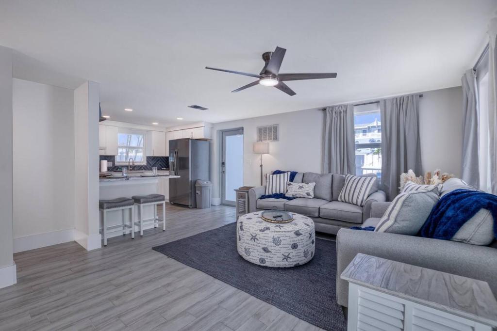 a living room with a couch and a ceiling fan at Restorative Escape-Moonlit Waters-Steps to beach. in Holmes Beach