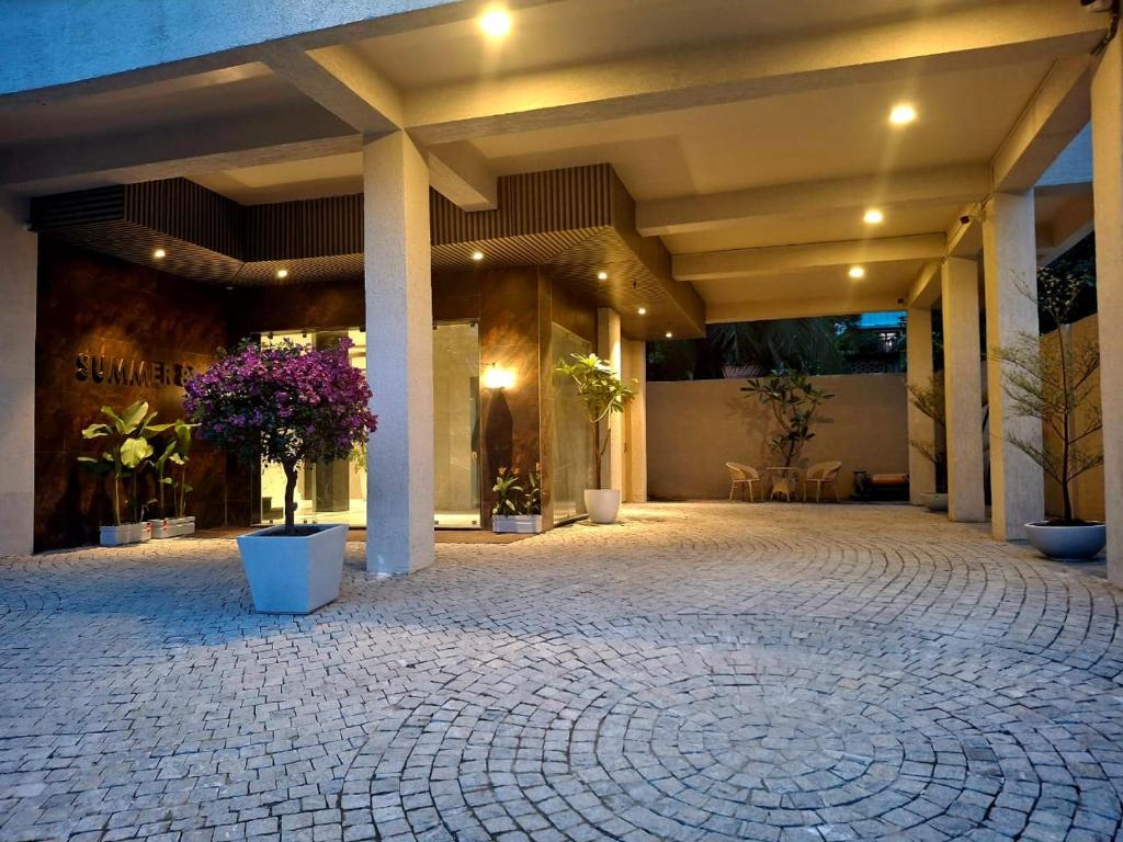 a large building with a courtyard with potted plants at SUMMER88 Boutique Hotel Azara, 4 Km from Airport, Near Kamakhya Temple in Guwahati