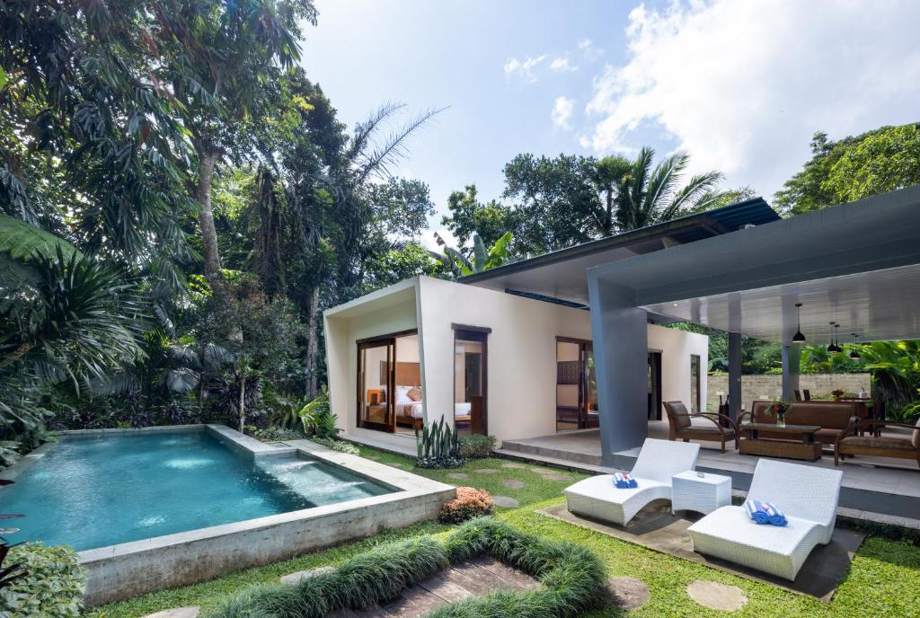 une cour arrière avec une piscine et une maison dans l'établissement Senetan Villas and Spa Resort, à Payangan