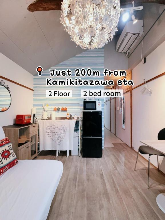a room with a bed and a table and a chandelier at 2 type room, Akira&chacha guest home杉並区世田谷direct to shinjuku for 13 min 上北沢3分 近涉谷新宿Suitable for three or more people in Tokyo