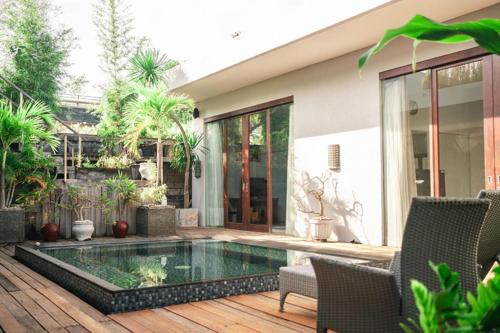 a swimming pool in the middle of a house at Jimbaran Beach Bliss Villa, Bali in Ngurah Rai International Airport