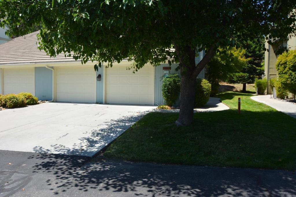 a house with a tree in front of a driveway at King- Lake Area in Bass Lake
