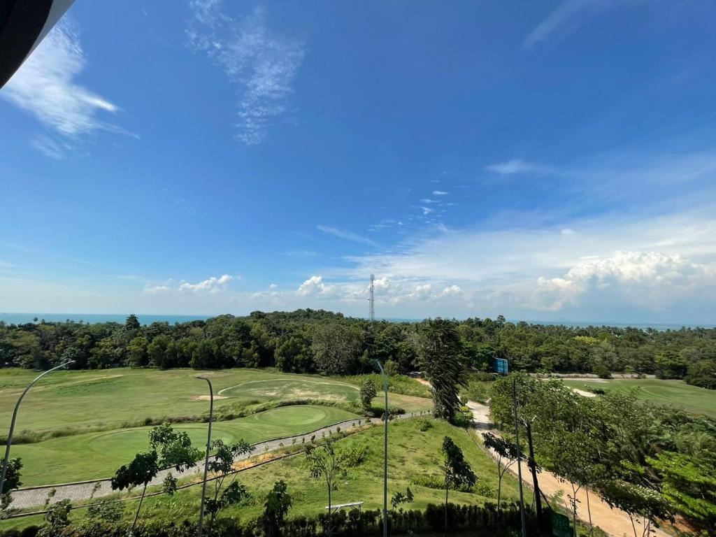 a view of a golf course with a green at The Nove Apartment Kalani Tower Sea View in Pulau Nongsa