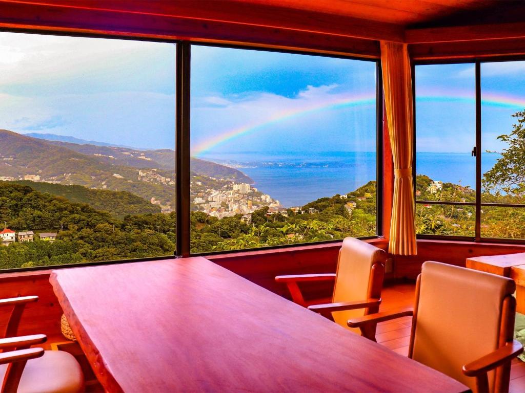 a room with a table and chairs and a rainbow at Yamaen Enso / Vacation STAY 32534 in Atami