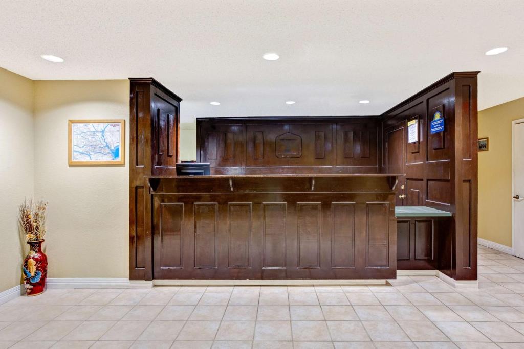 a large room with a large wooden barn door at Americas Best Value Inn & Suites La Porte/Houston in La Porte