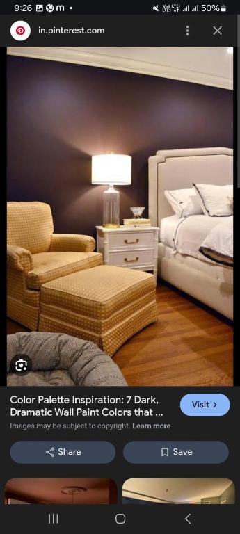 a page of a bedroom with a bed and a chair at Rose guest house in Anantnāg