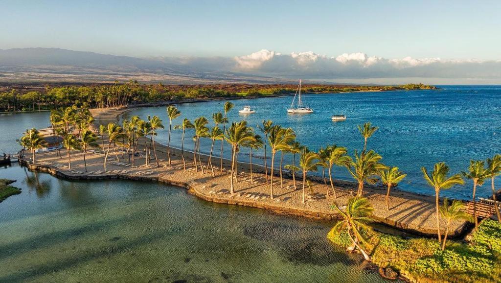 an aerial view of a river with palm trees and boats at Waikoloa Beach Condo in Waikoloa