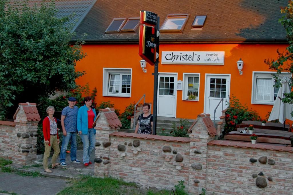 a group of people standing in front of a building at Christel's Pension in Brandenburg an der Havel