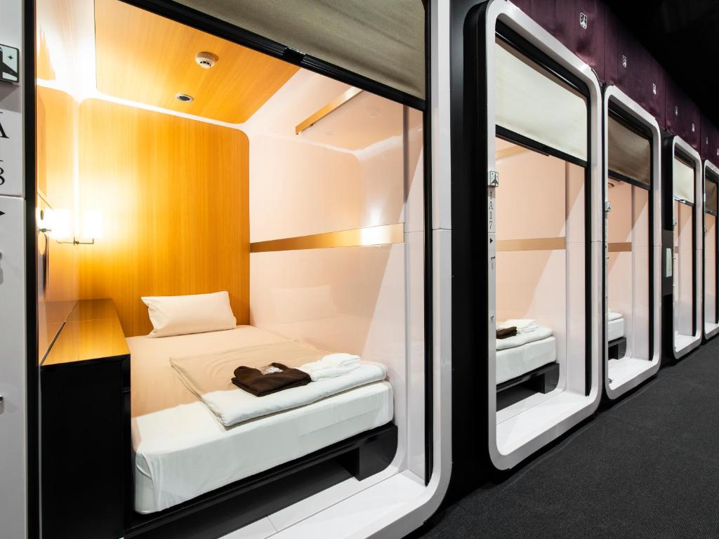 Postel nebo postele na pokoji v ubytování FIRSTCABIN Kyoto Nijojo