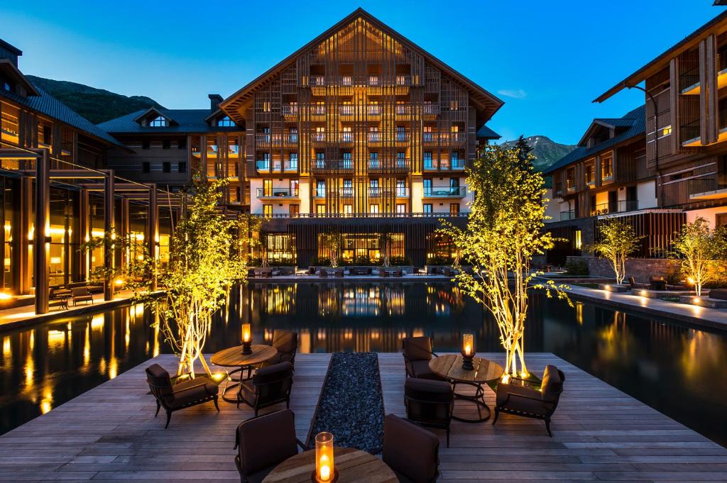 a hotel with a pool in front of a building at The Chedi Andermatt in Andermatt