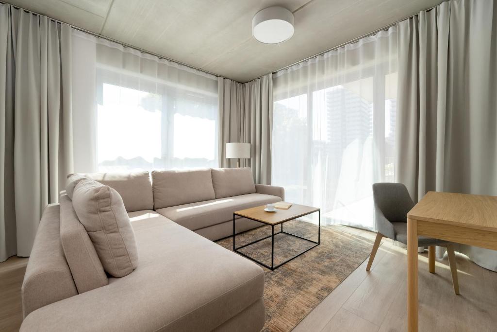 a living room with a couch and a table at Luxury Apartments with Parking and Air Conditioning near Wrocław City Center by Renters Prestige in Wrocław