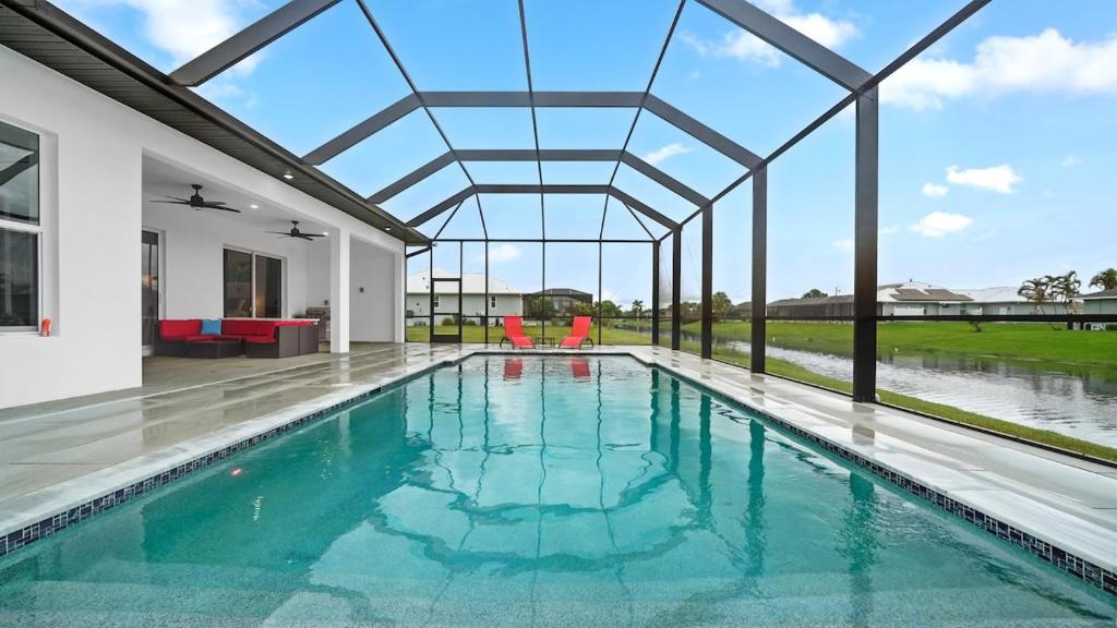 an indoor swimming pool with a glass ceiling at Modern Florida Escape in Rotonda West