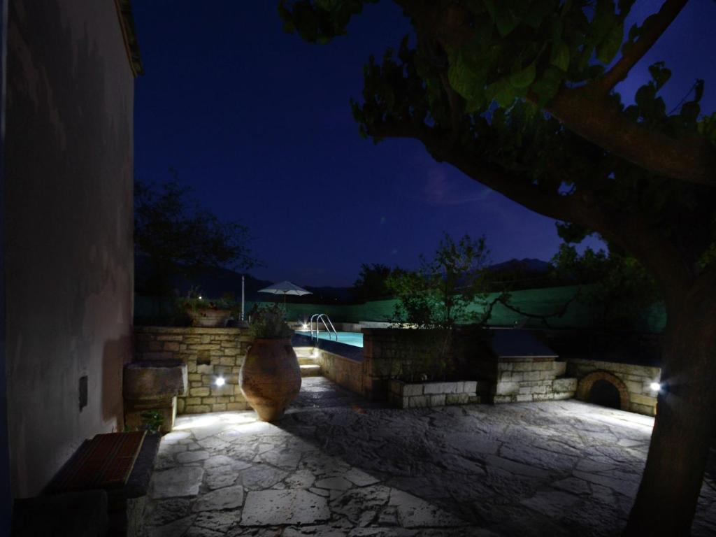 a night view of a patio with a swimming pool at Villa in Crete with Vineyard Experience in Kalamítsion Alexándrou