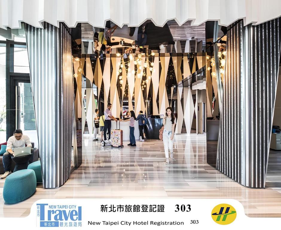 a lobby of a building with people walking around at HOTEL CHAM CHAM - Taipei in Taipei