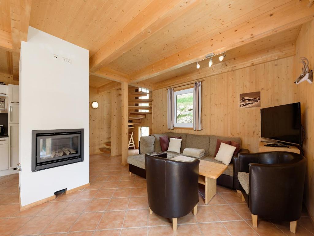 a living room with a couch and a fireplace at Holzchalet nahe Skilift Hohentauern in Hohentauern
