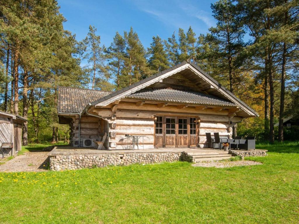 a log cabin in the woods with a yard at 8 person holiday home in Ebeltoft in Ebeltoft